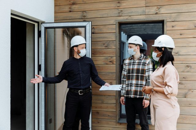 Property Management Professionals Entering a House to Inspect It Before Move-In